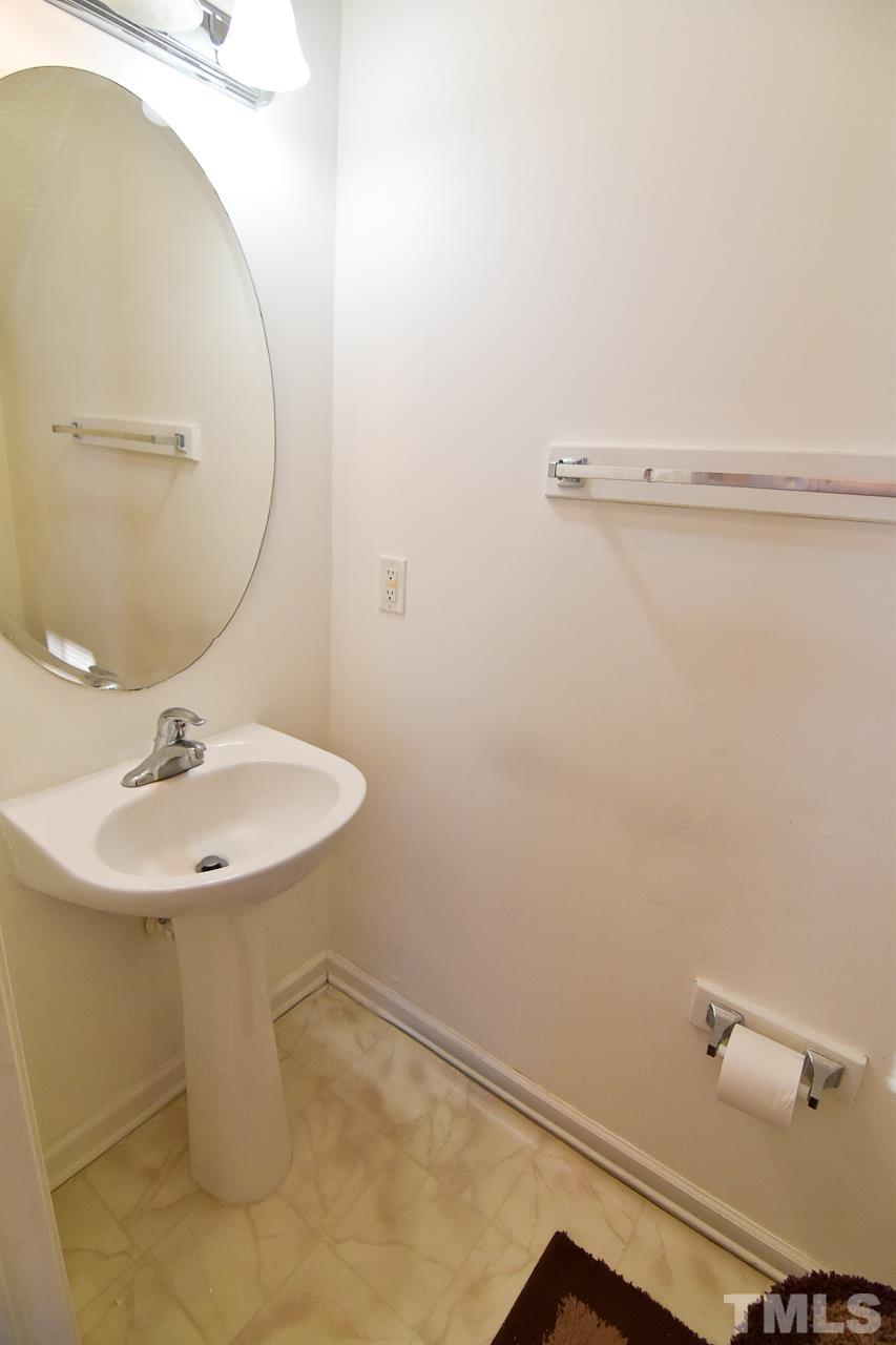 5709 Forest Point Road Raleigh, NC 27610 - Photo 9 of 19 a bathroom with a sink a toilet and mirror