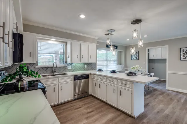 a kitchen with sink stove and cabinets