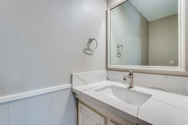 a bathroom with a sink and vanity