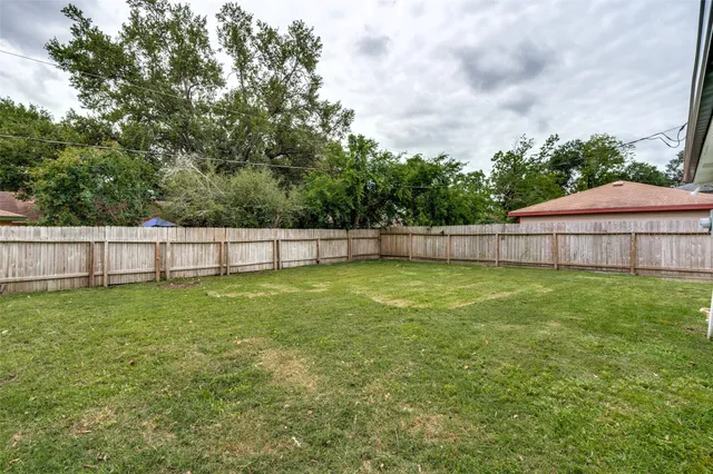 a view of yard with outdoor space and wooden fence