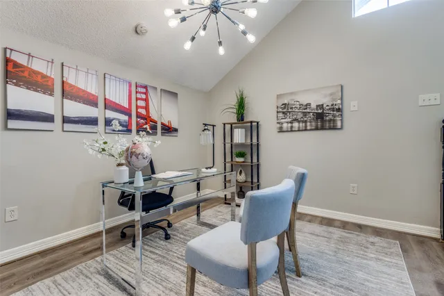 a view of a room with furniture and wooden floor