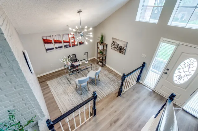 a view of a room with furniture and wooden floor