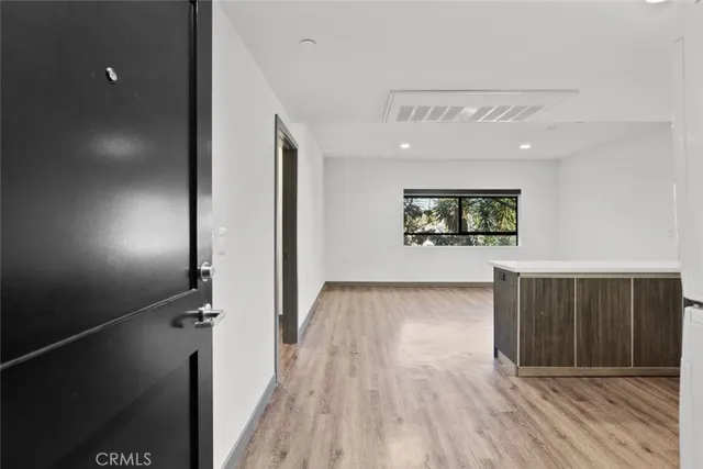 a view of a street with wooden fence
