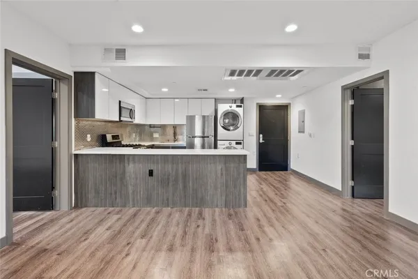 a kitchen with a sink a refrigerator and window