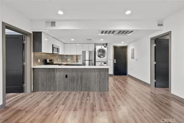 a kitchen with a sink a refrigerator and window