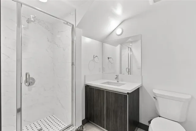 a kitchen with stainless steel appliances a refrigerator and a stove top oven