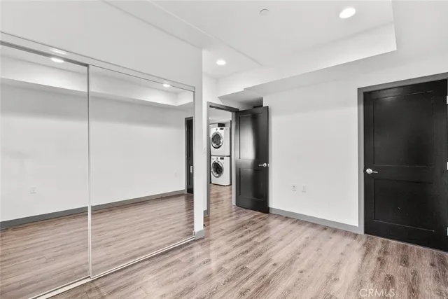 a view of a yard with plants and wooden fence