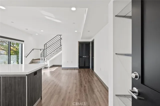a view of entryway and hall with wooden floor