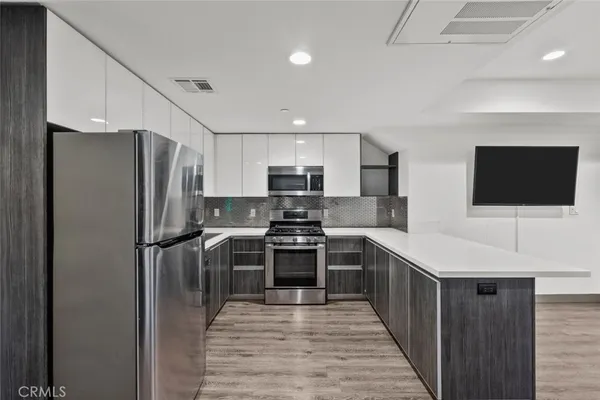 a kitchen with a refrigerator stove and microwave