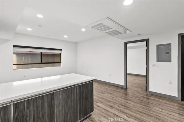 a kitchen with stainless steel appliances kitchen island granite countertop a sink and a refrigerator