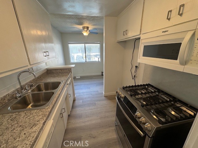 7524 Haskell Avenue, Unit 5 Van Nuys, CA 91406 - Photo 12 of 15 a kitchen that has a sink and a stove