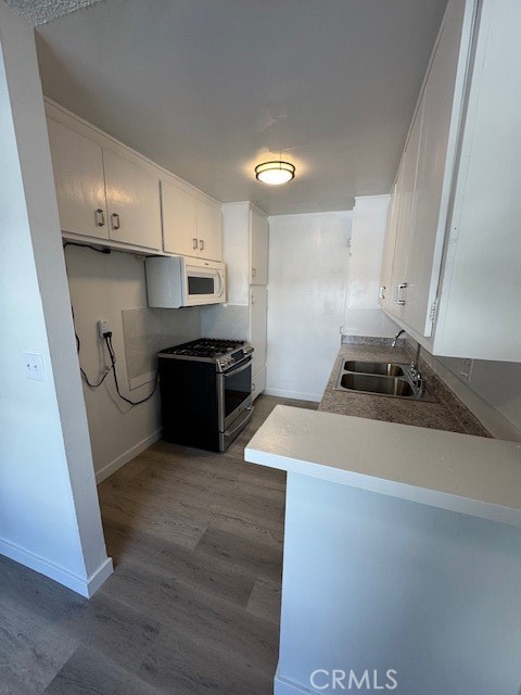 7524 Haskell Avenue, Unit 5 Van Nuys, CA 91406 - Photo 9 of 15 a kitchen with stainless steel appliances a sink and a stove