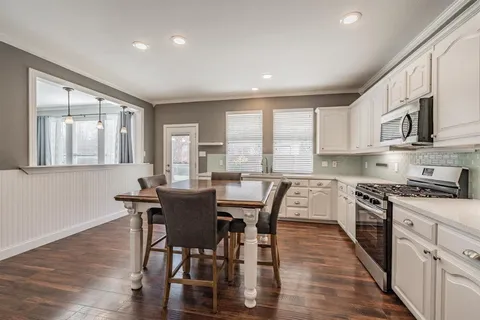 a dining room with furniture and wooden floor