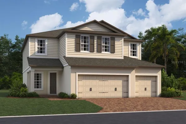 a front view of a house with a garden and garage