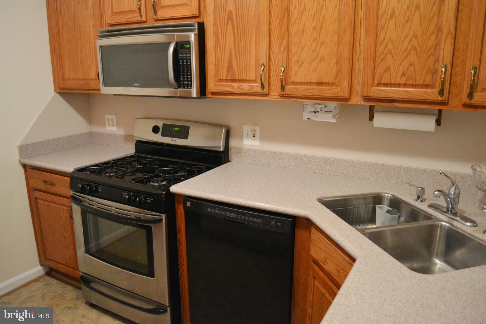 2117 Rolander Street Hyattsville, MD 20783 - Photo 4 of 30 a kitchen with granite countertop a sink stove and cabinets
