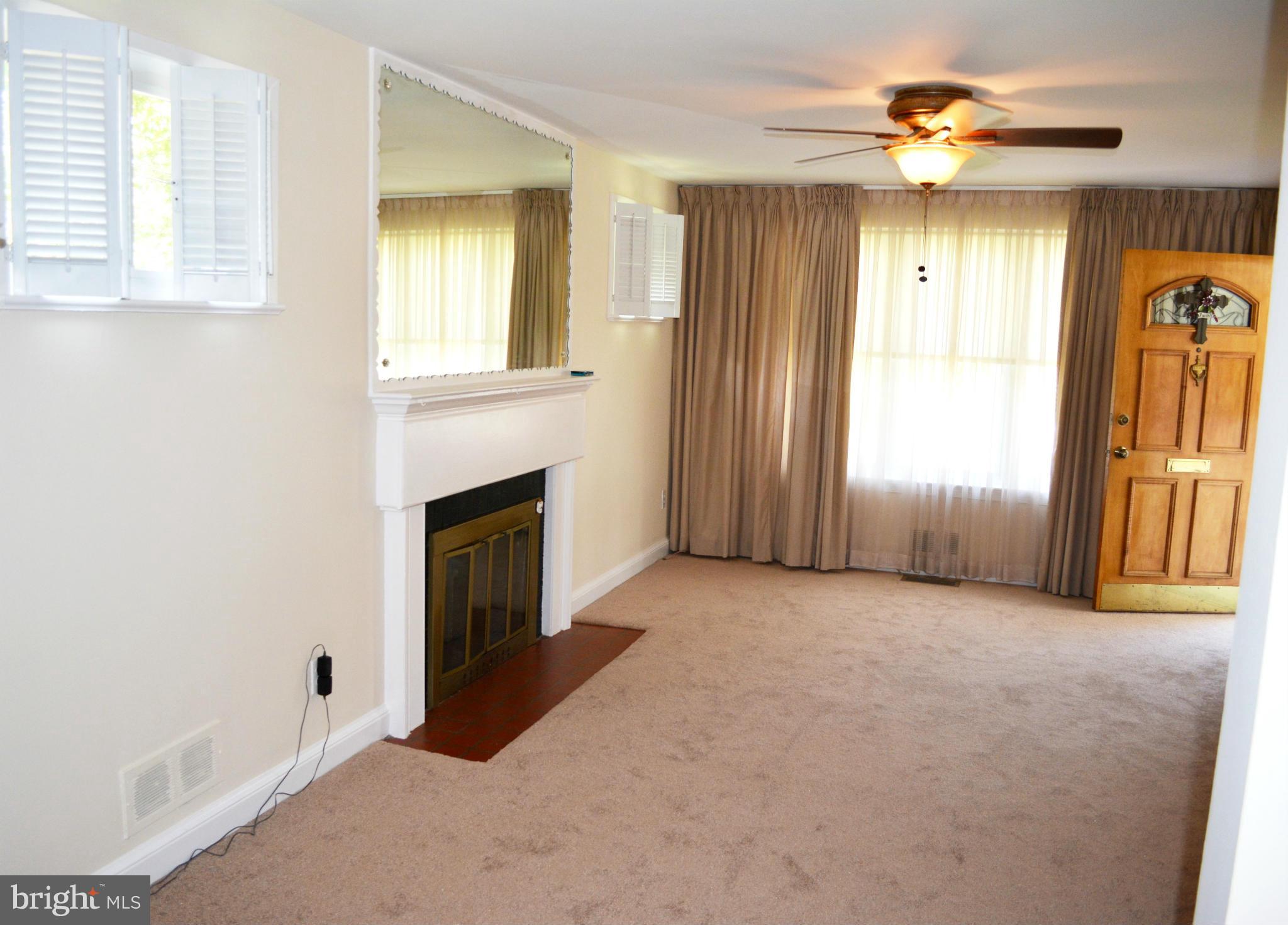 2117 Rolander Street Hyattsville, MD 20783 - Photo 8 of 30 an empty room with windows and a fireplace