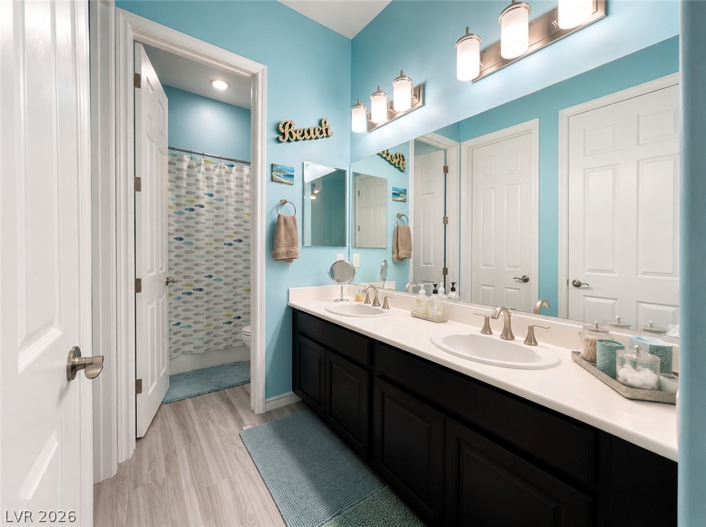 9724 University Ridge Avenue Las Vegas, NV 89149 - Photo 16 of 61 Double vanity and modern fixtures enhance this bathroom's clean, coastal ambiance.