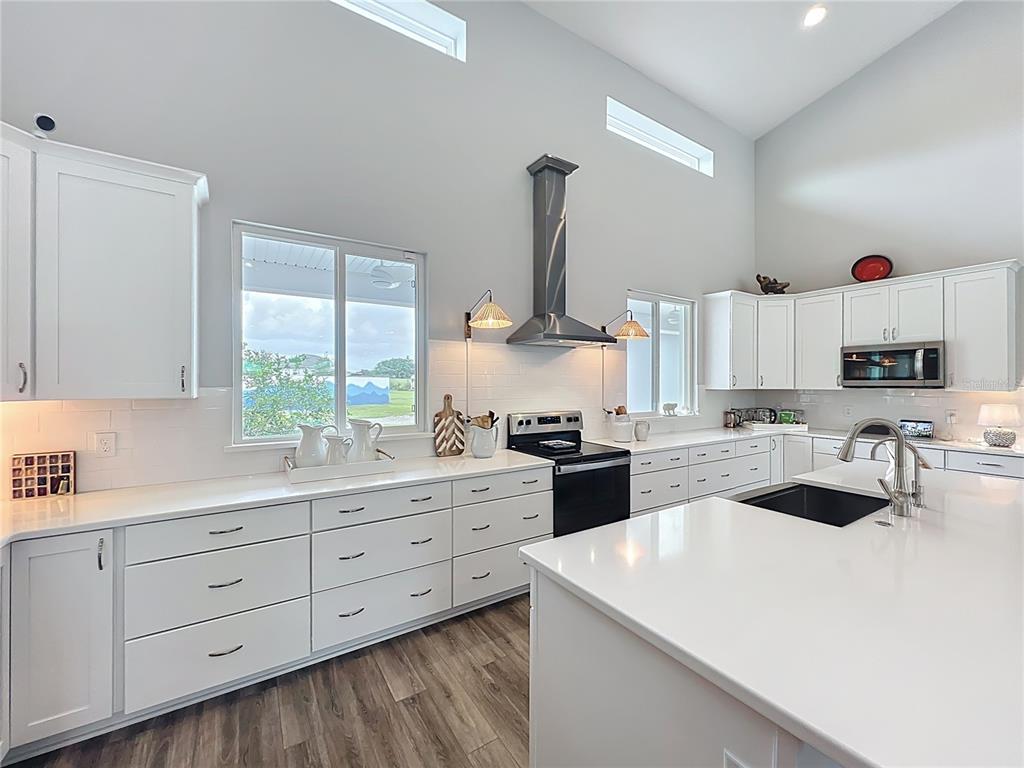 10220 Bay Lake Road Groveland, FL 34736 - Photo 13 of 67 a kitchen with cabinets a sink and appliances
