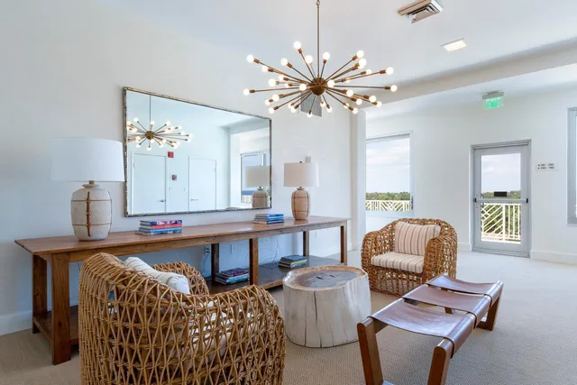 a living room with furniture a table and chair