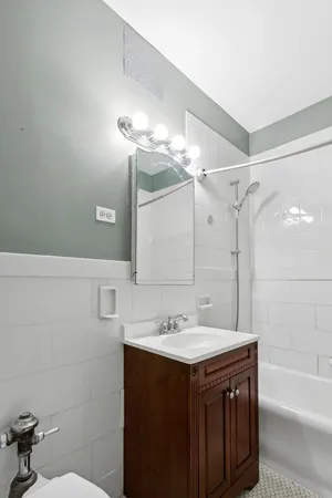 a bathroom with a sink vanity tub and shower