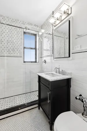 a bathroom with a sink mirror vanity and toilet