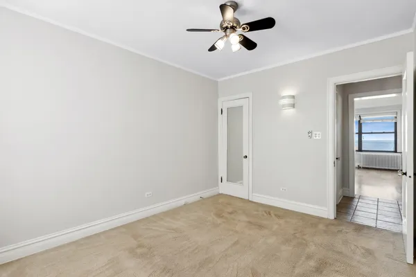 a view of a room with a ceiling fan