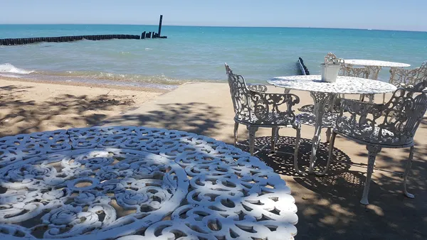 a view of a swimming pool with a table and chairs