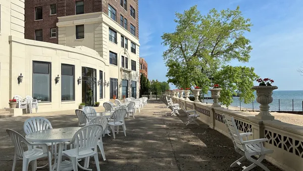 a view of a patio with a table and chairs and potted plants