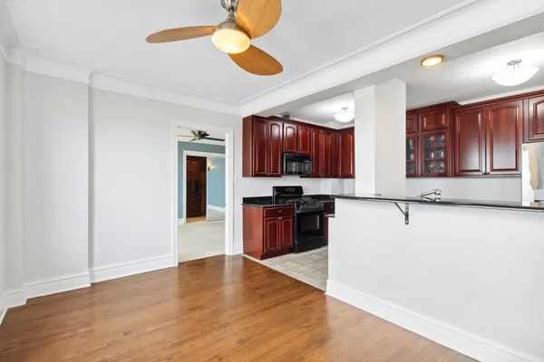 a view of kitchen with refrigerator stove microwave and cabinets