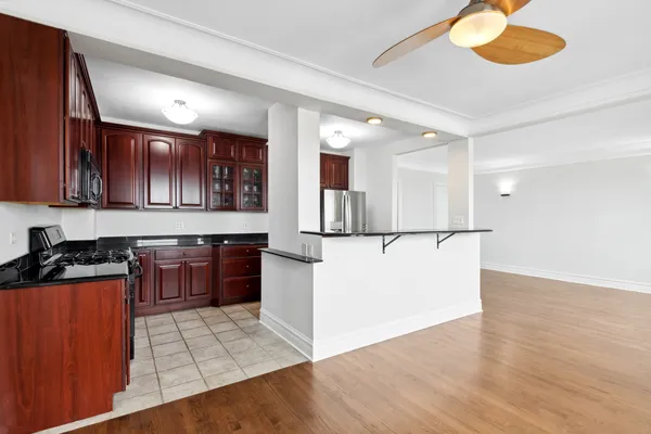 a large kitchen with stainless steel appliances granite countertop a stove a sink and a refrigerator