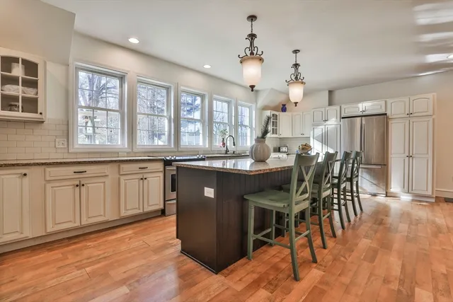 a kitchen with a table chairs and wooden floor