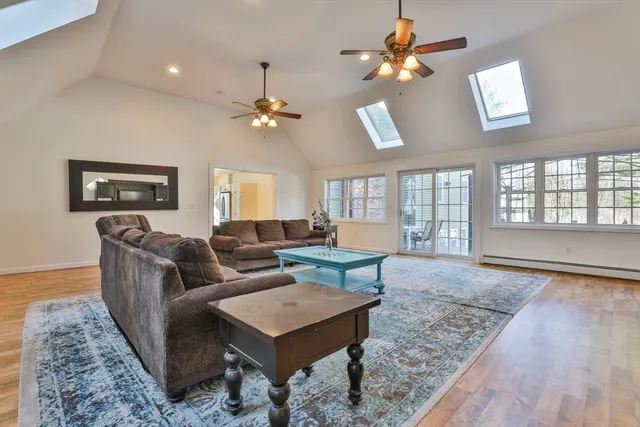 a living room with furniture a chandelier and a table