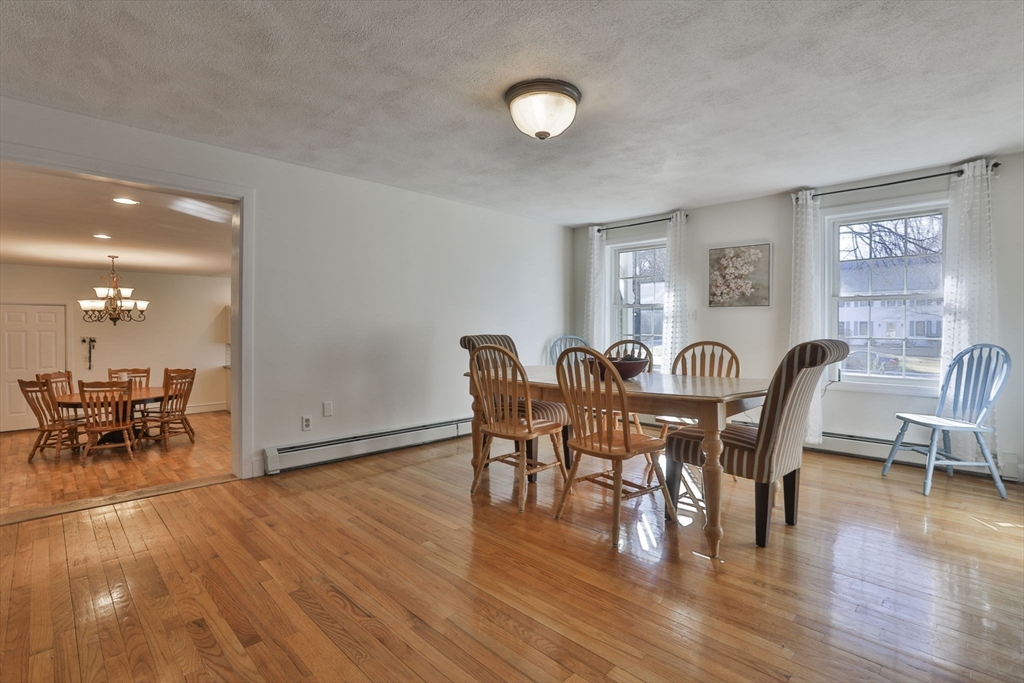 207 Oakridge Road Plaistow, NH 03865 - Photo 22 of 42 a view of a dining room with furniture and wooden floor