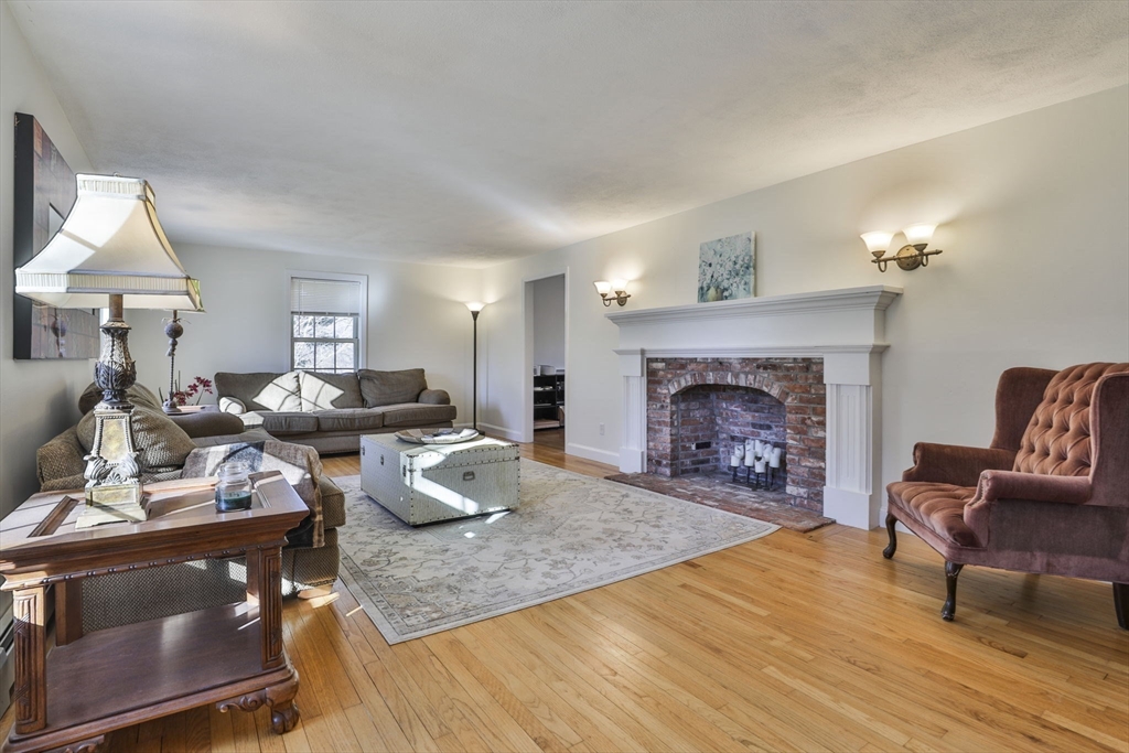 207 Oakridge Road Plaistow, NH 03865 - Photo 26 of 42 a living room with furniture and a fireplace