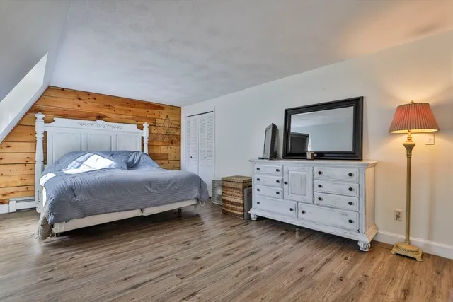 a bedroom with a bed and a dresser