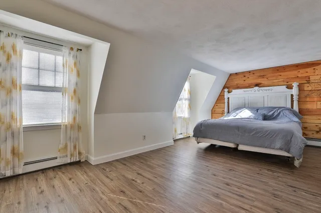 a bedroom with a bed and window