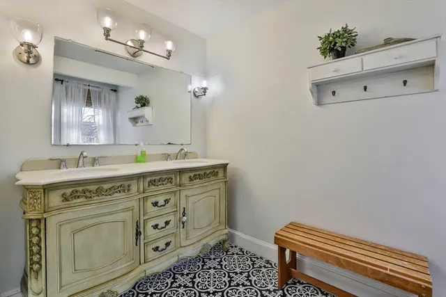 a spacious bathroom with a granite countertop sink a mirror and a