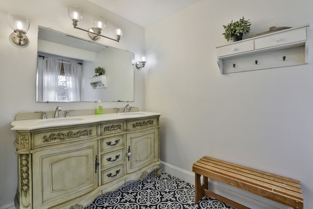 207 Oakridge Road Plaistow, NH 03865 - Photo 35 of 42 a spacious bathroom with a granite countertop sink a mirror and a