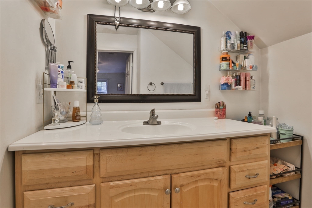 207 Oakridge Road Plaistow, NH 03865 - Photo 39 of 42 a bathroom with a sink and a mirror