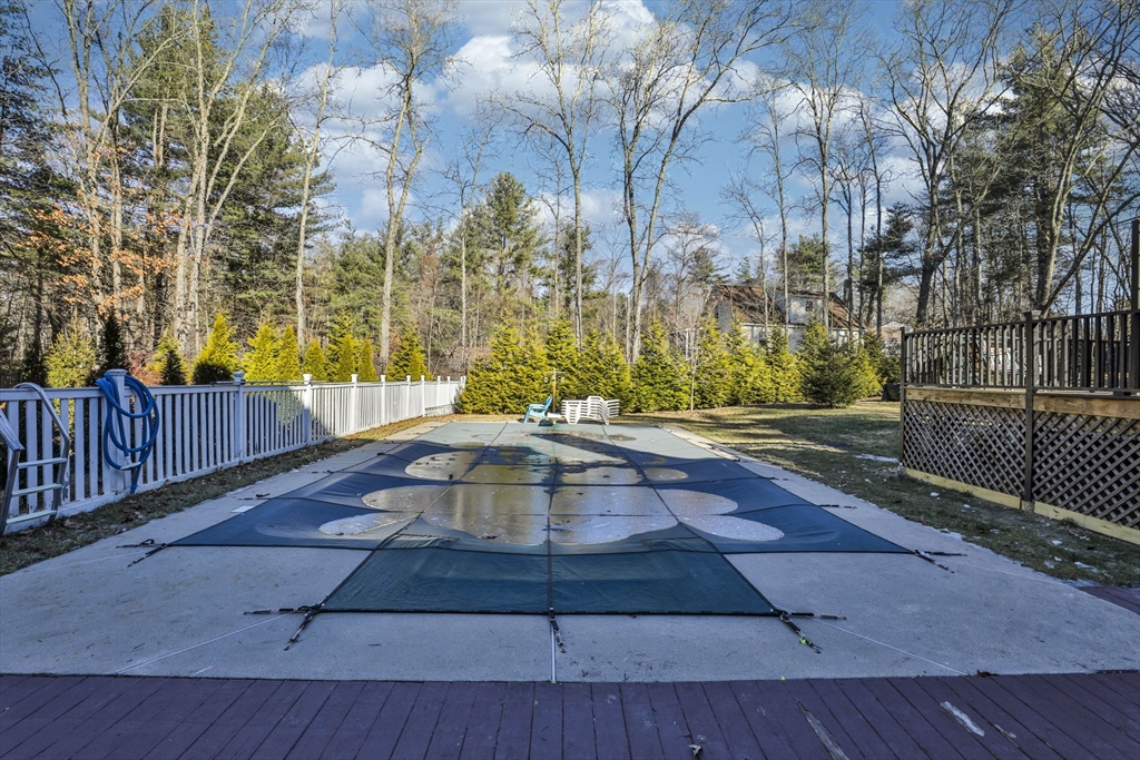 207 Oakridge Road Plaistow, NH 03865 - Photo 8 of 42 a view of backyard with large trees and wooden fence