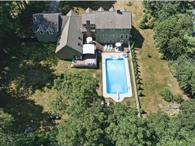 an aerial view of a house with a yard
