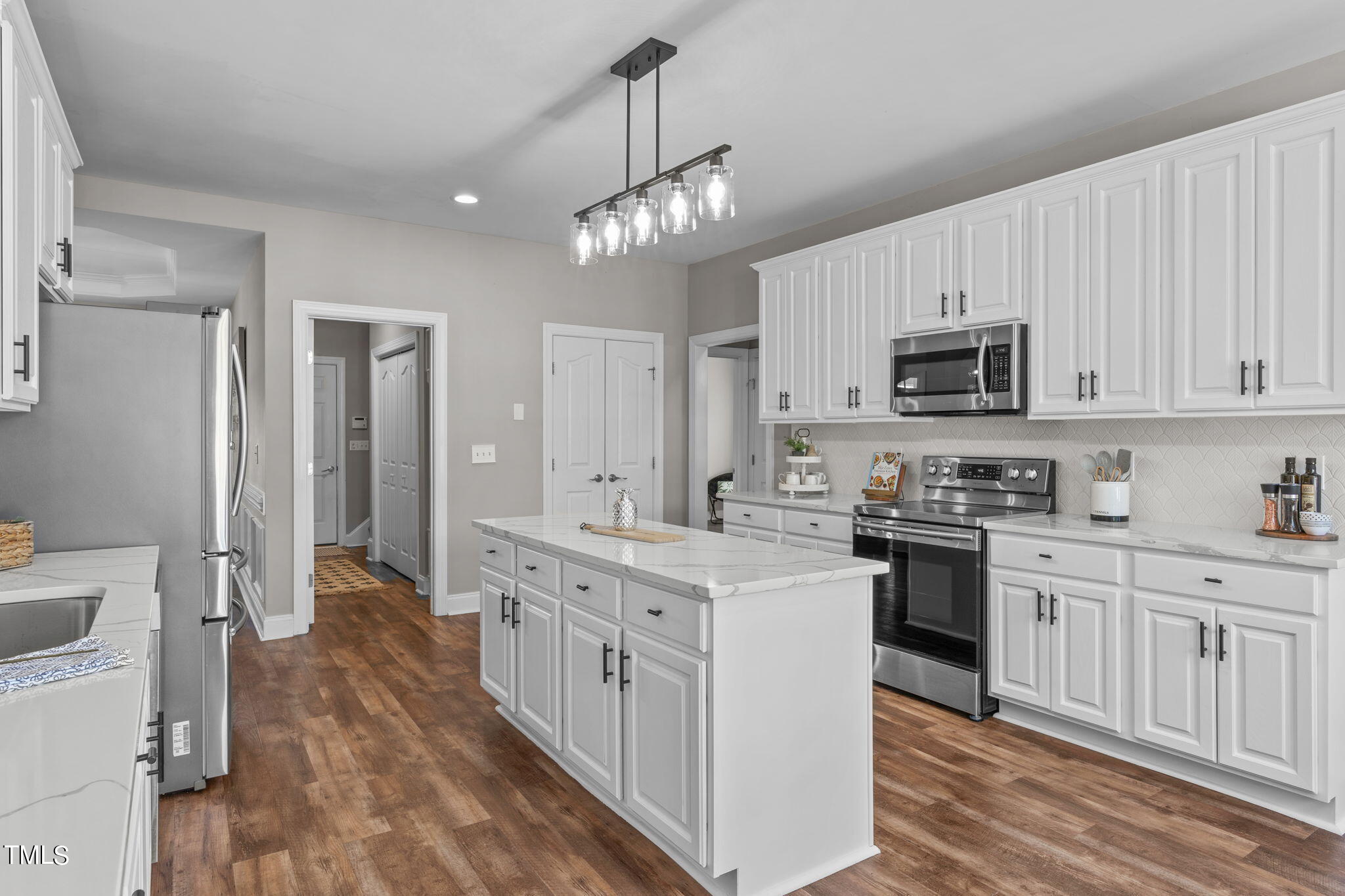 7409 Ladora Drive Willow Spring, NC 27592 - Photo 13 of 33 a kitchen with stainless steel appliances a stove sink and cabinets