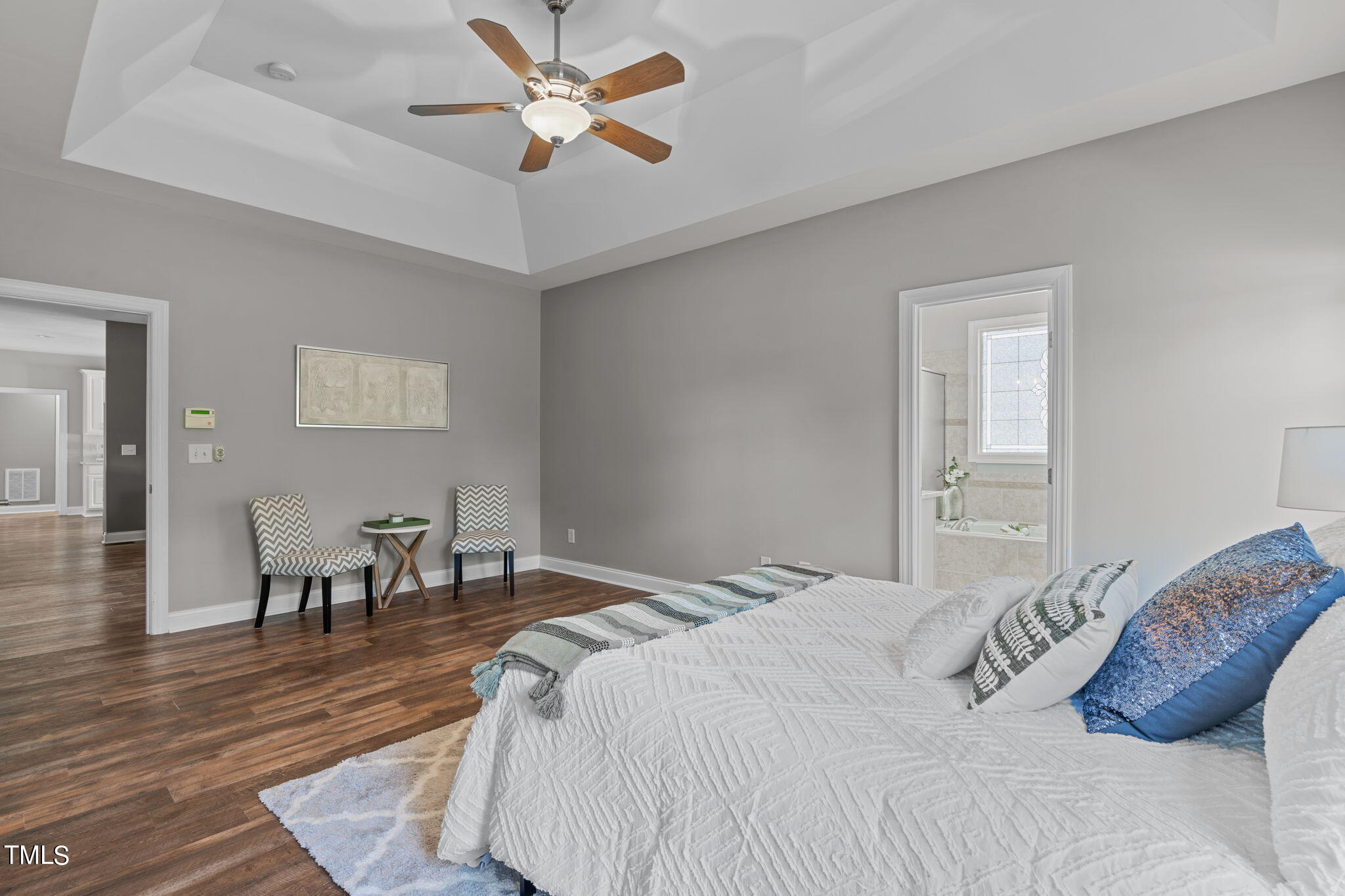 7409 Ladora Drive Willow Spring, NC 27592 - Photo 17 of 33 a bedroom with a bed and a chandelier