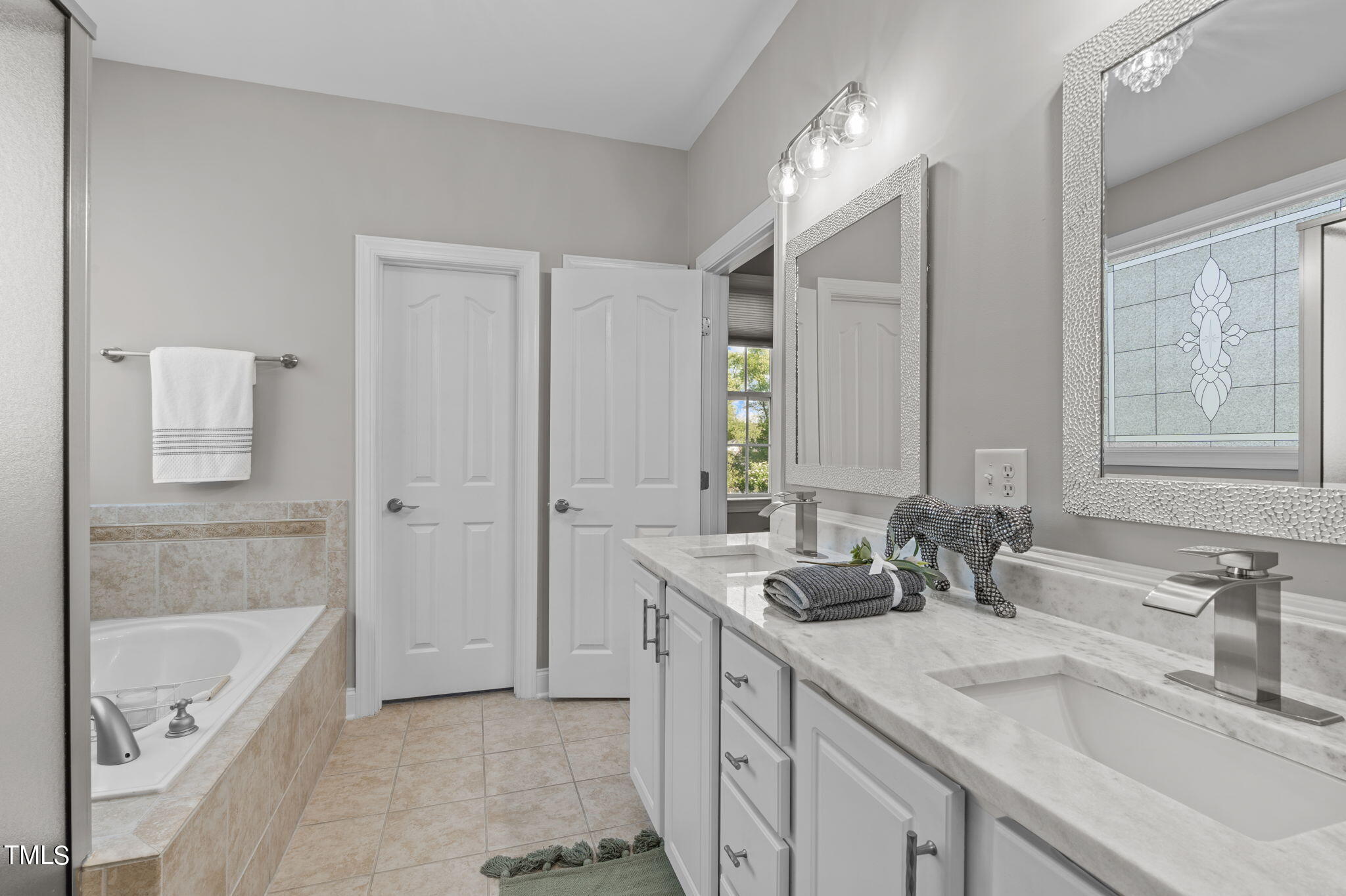 7409 Ladora Drive Willow Spring, NC 27592 - Photo 19 of 33 a bathroom with a tub sink and mirror