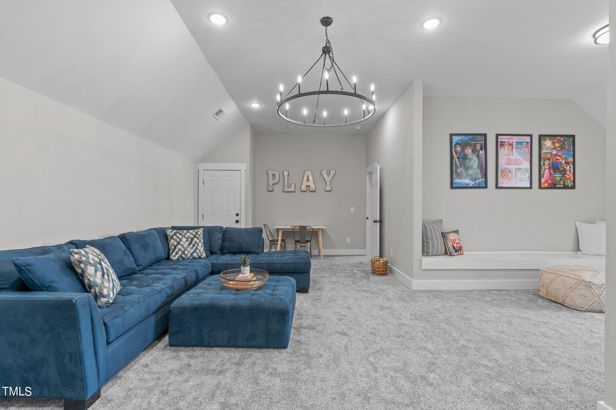 7409 Ladora Drive Willow Spring, NC 27592 - Photo 23 of 33 a living room with furniture a chandelier and a dining table