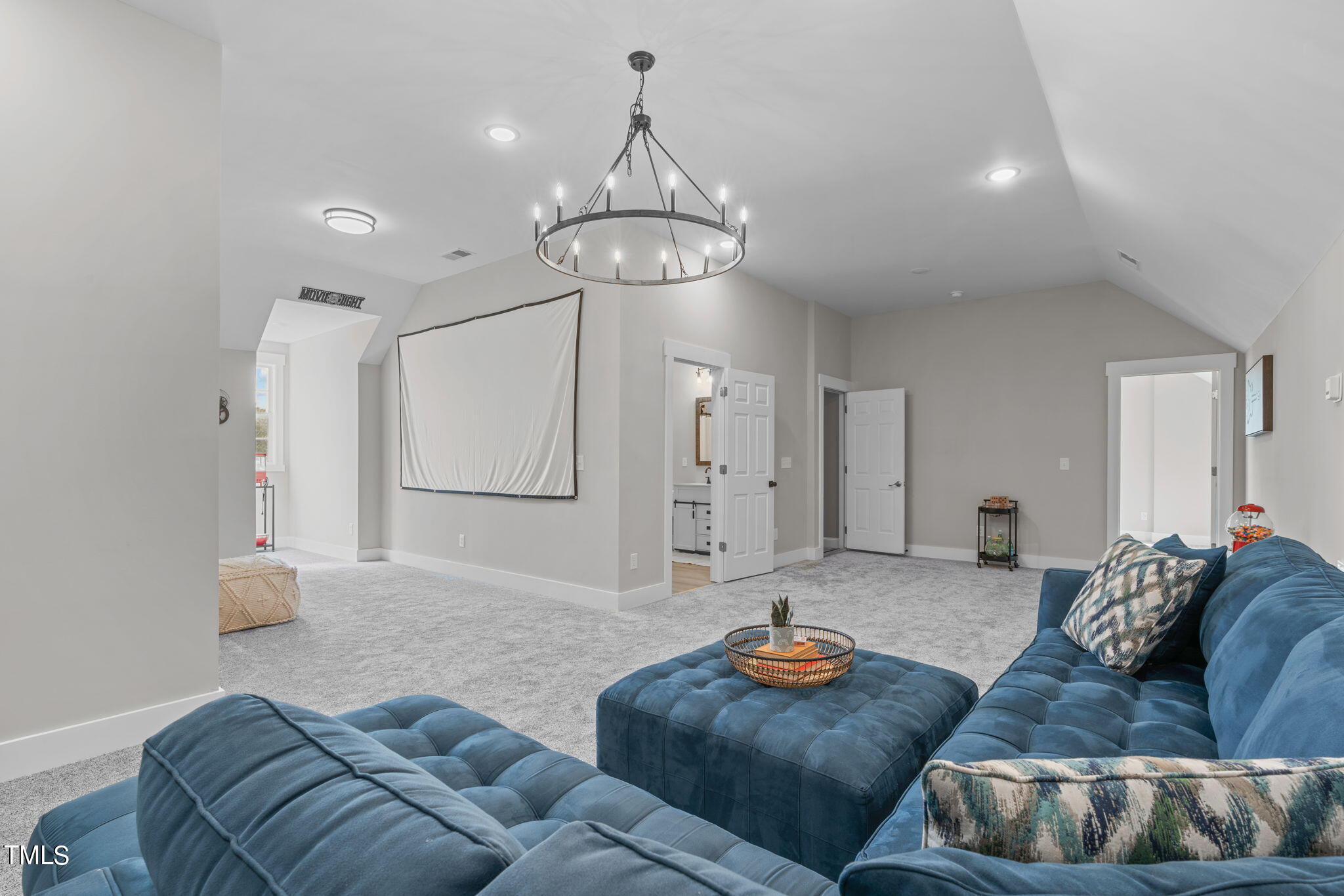 7409 Ladora Drive Willow Spring, NC 27592 - Photo 24 of 33 a living room with furniture kitchen view and a chandelier