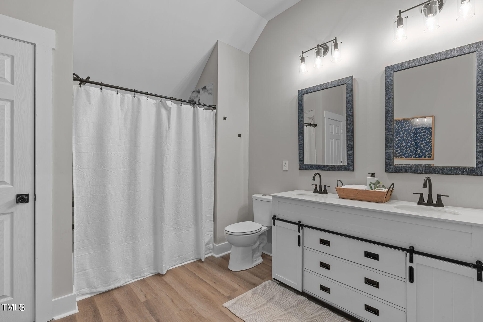 7409 Ladora Drive Willow Spring, NC 27592 - Photo 28 of 33 a bathroom with double sink and a mirror