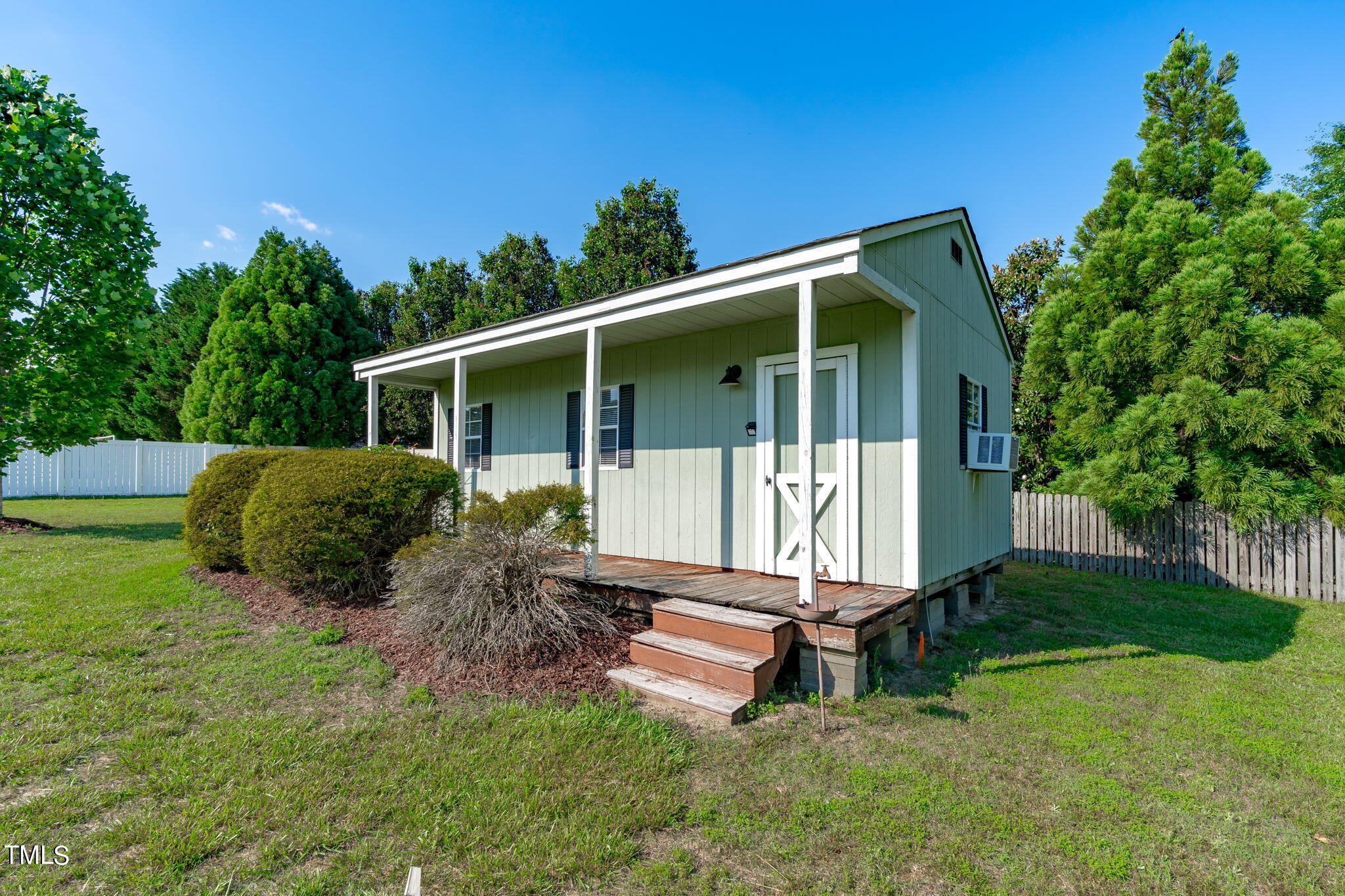 7409 Ladora Drive Willow Spring, NC 27592 - Photo 32 of 33 a view of backyard with a barn and a large tree