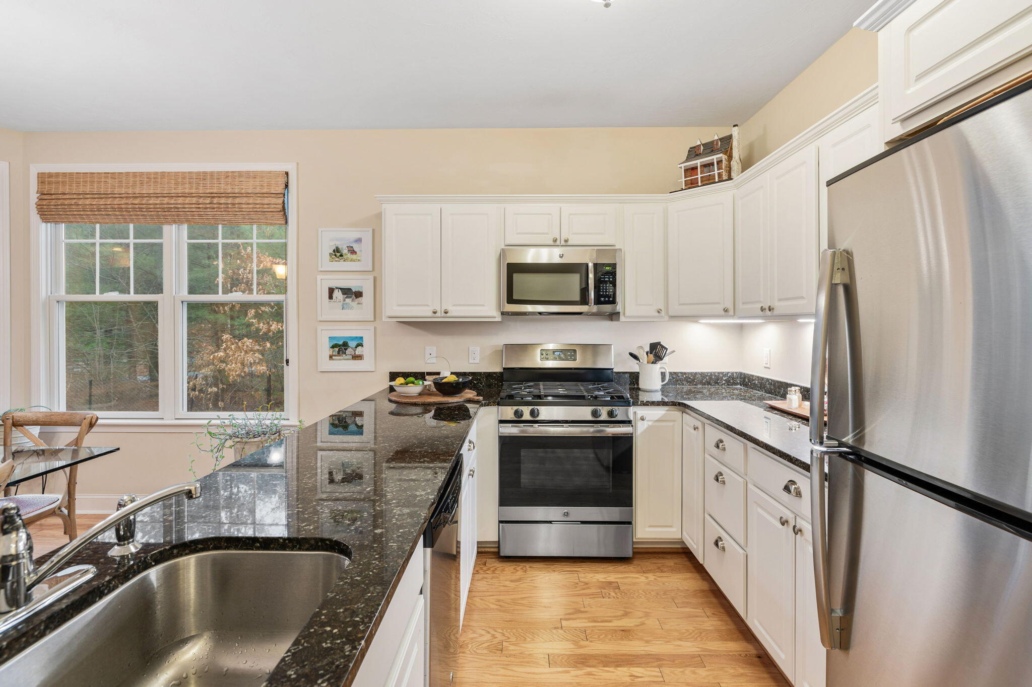 16 Grey Hawk Drive, Unit 16 Mashpee, MA 02649 - Photo 12 of 29 a kitchen with stainless steel appliances granite countertop a sink stove microwave and refrigerator