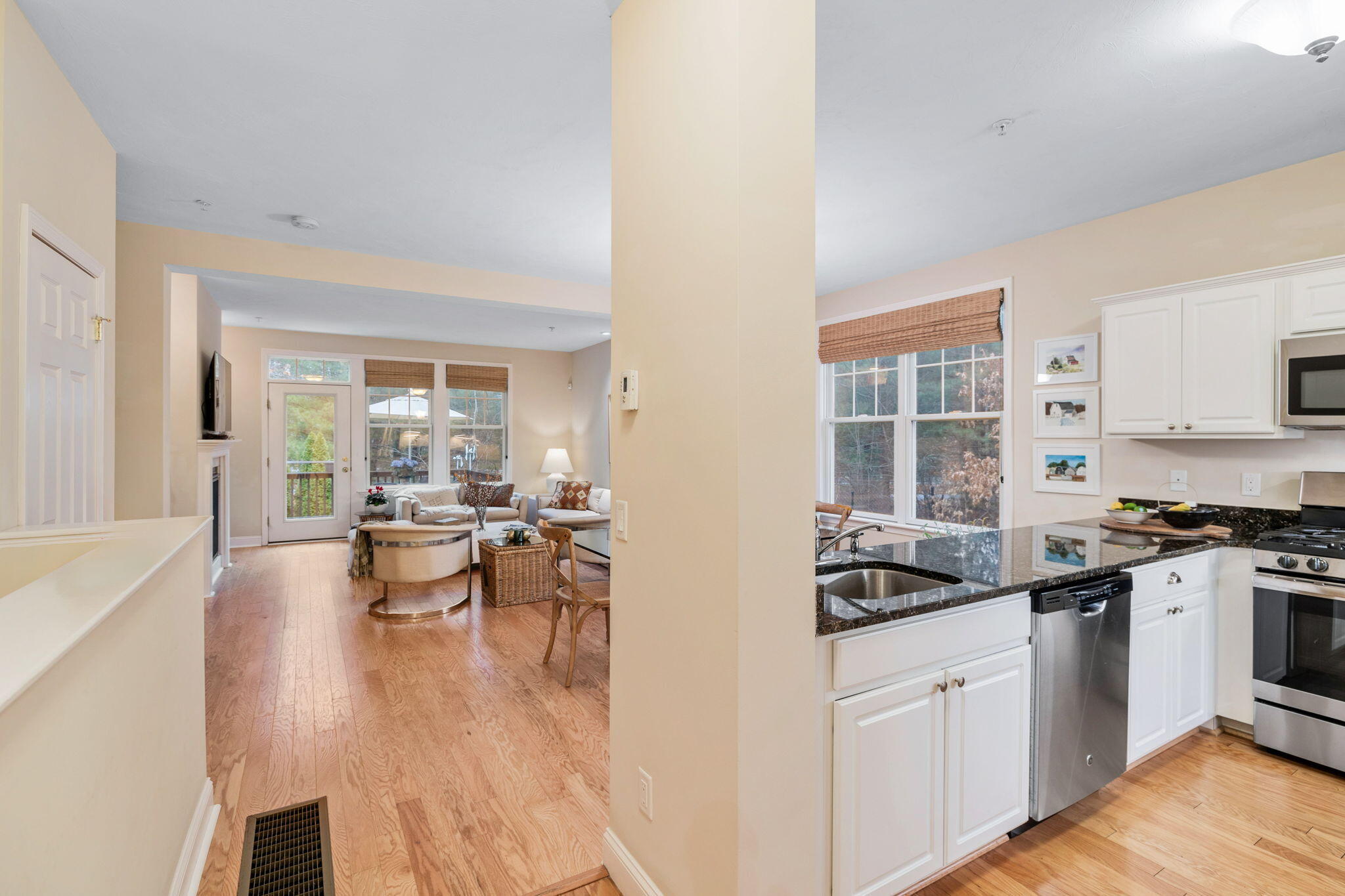 16 Grey Hawk Drive, Unit 16 Mashpee, MA 02649 - Photo 15 of 29 a kitchen with a sink stove and wooden cabinets